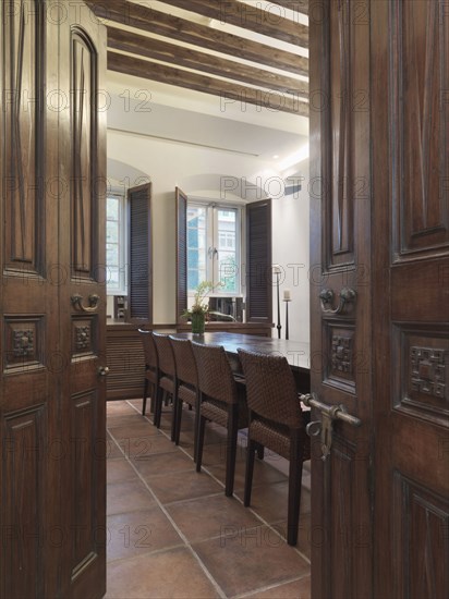 Opening wooden doors leading to dining room