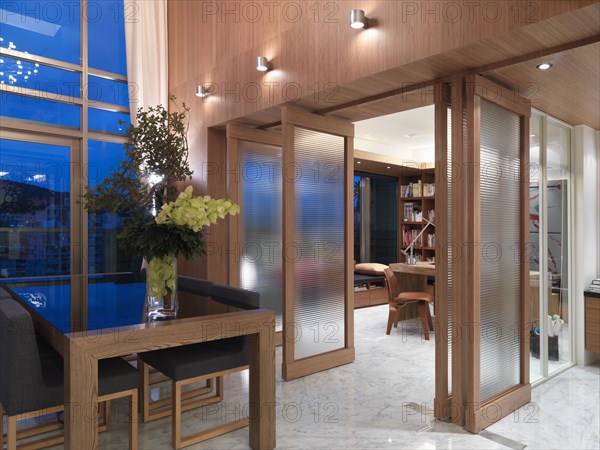 Modern dining area and home office separated by rotating doors