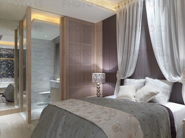 Elegant bedroom with drapes above bed