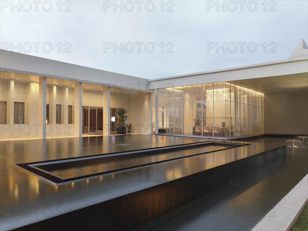 Large infinity pool out front of modern home