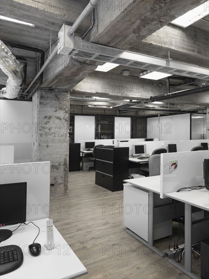 Modern industrial office with rows of computers