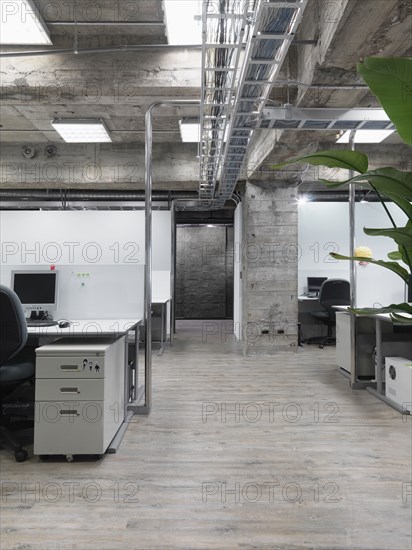 Modern industrial office with rows of computers