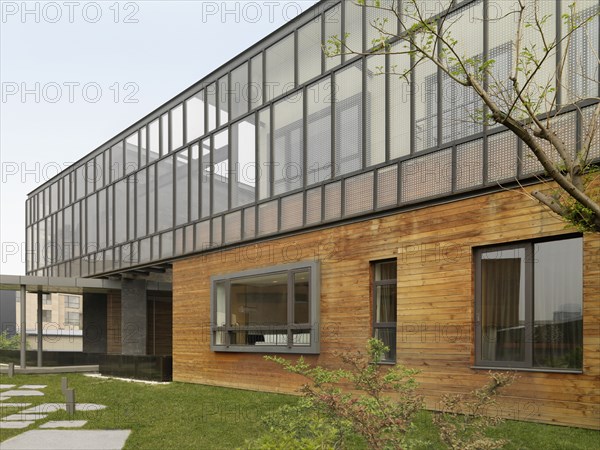 Exterior view multiple story modern home with hardwood siding
