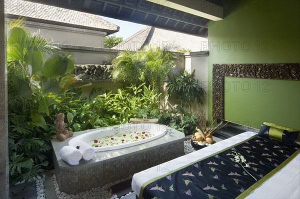 Spa room with massage table and hot tub