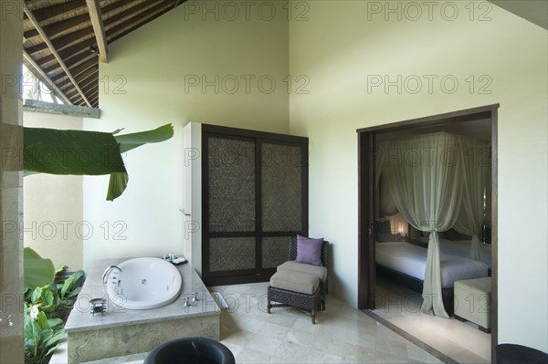 Bathroom with hot tub open to outside