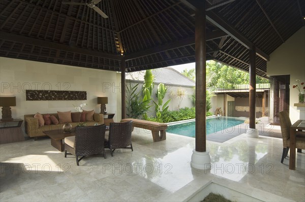 Contemporary sitting area opened up to private pool