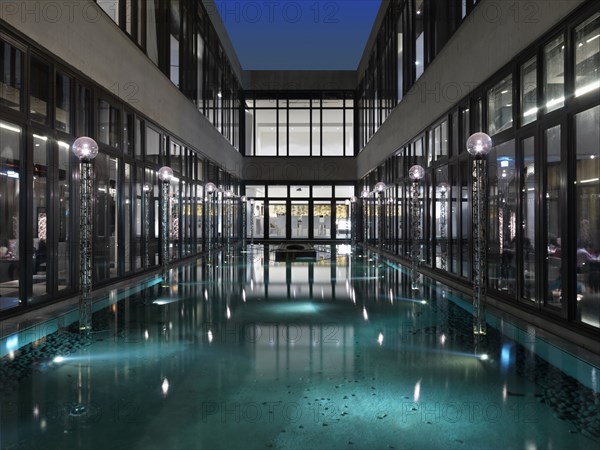 Reflection pool surrounded by modern glass building