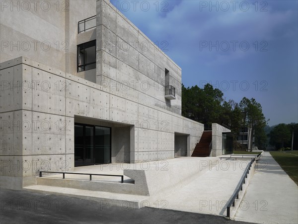 Modern cement patio and hardwood staircase