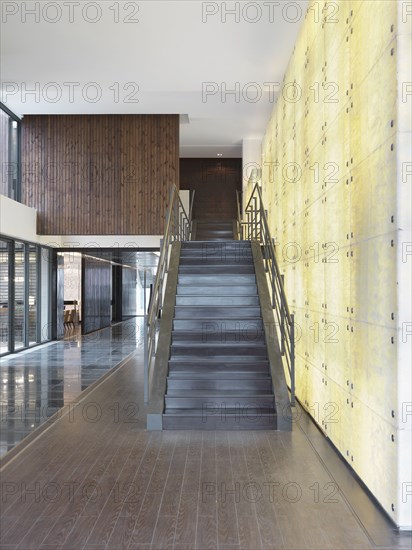 Modern staircase in front of illuminated wall