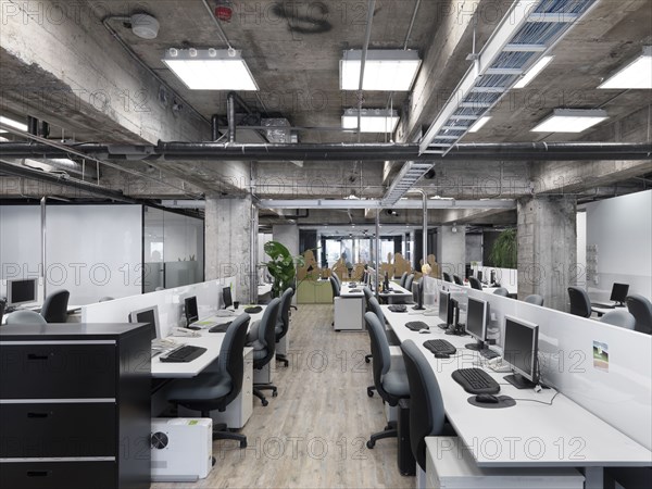 Modern industrial office with rows of computers