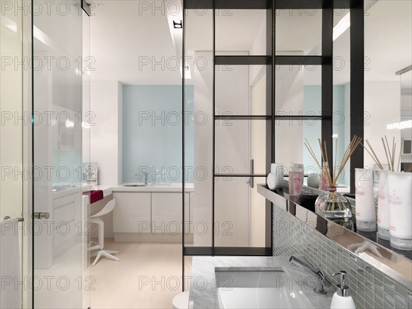 Beauty products on ledge above modern sink