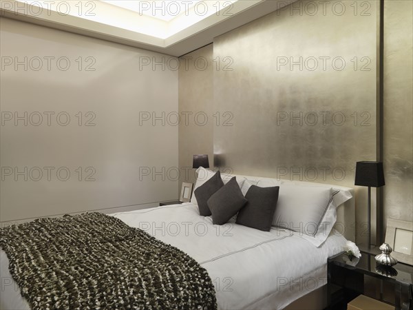 Modern bedroom with gold wall