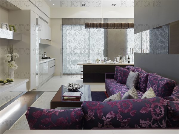 Modern purple sofa outside kitchen