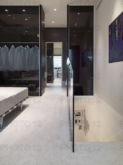 Carpeted hallway and top of staircase in modern home