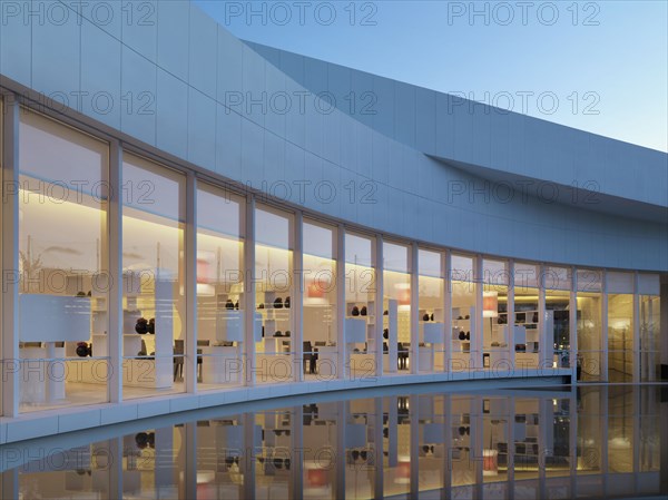 Reflecting pool outside modern building at dusk