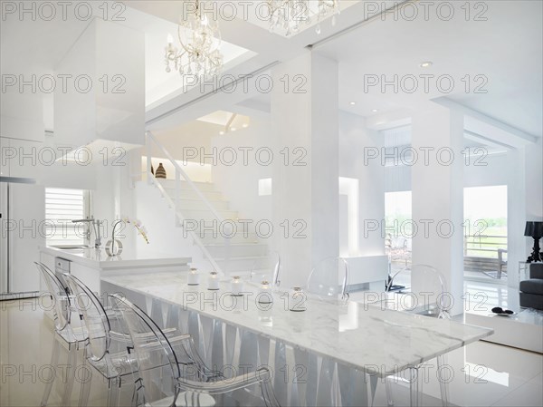 Marble dining table with clear plastic chairs