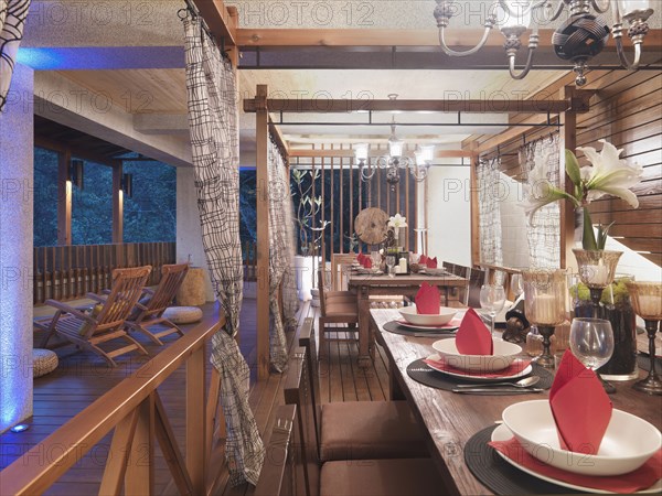 Dining table with chandeliers set up on back deck