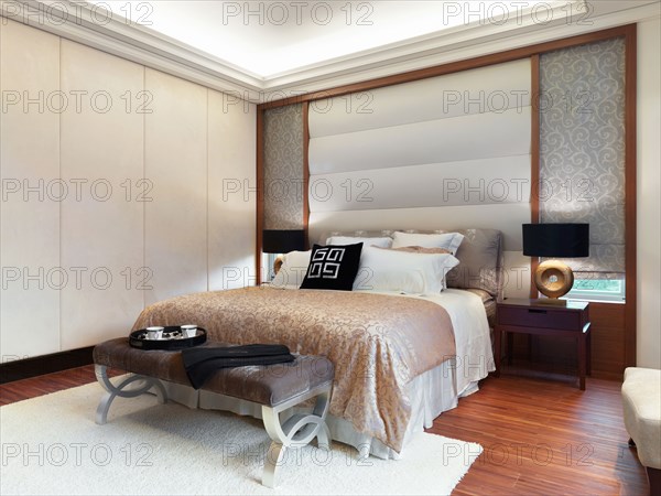 Bedroom with hardwood floor and white carpet
