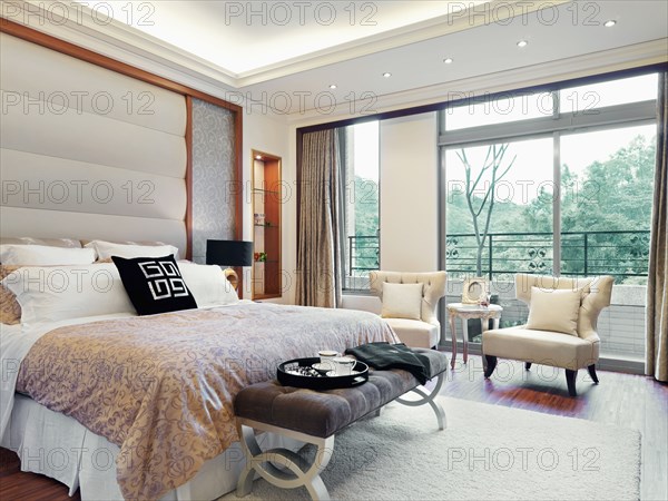Modern master bedroom with large picture windows