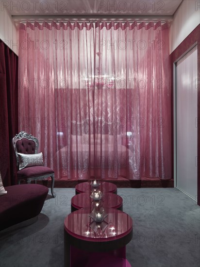 Chic bedroom with pink glass coffee table and grey carpet