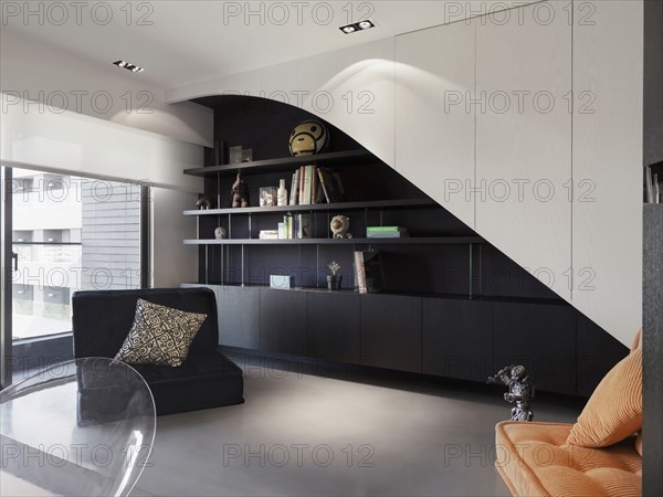 Modern style office with bookshelf and love seat
