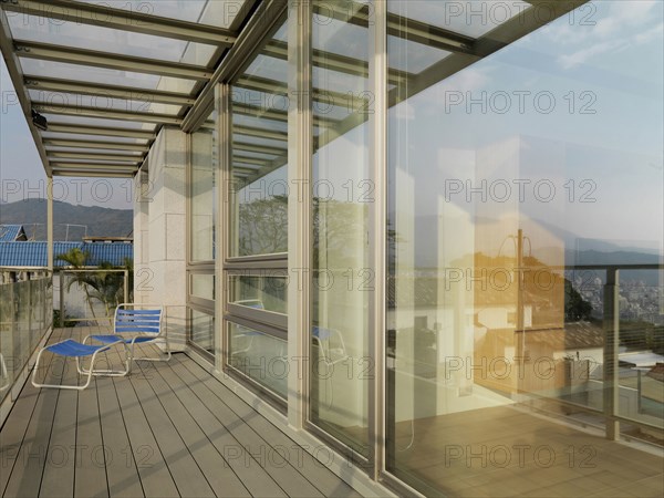 Lounge chair on deck outside modern home