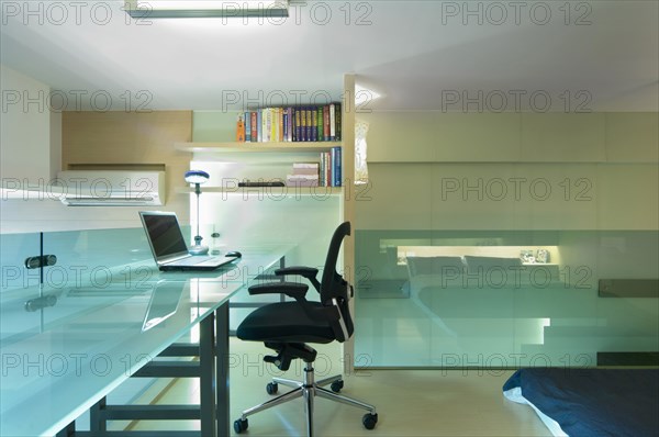 Desk and office chair in bedroom of modern home