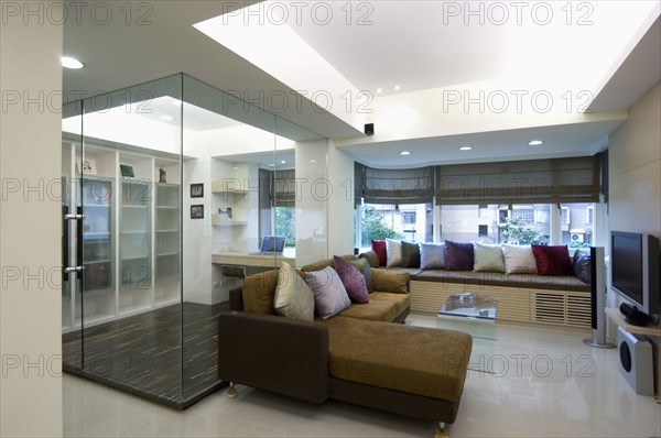 Interior of a modern living room with brown sectional sofa