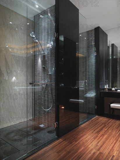 Dark glass shower in bathroom with hardwood floor