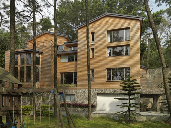 Exterior view of cabin with swing set in backyard