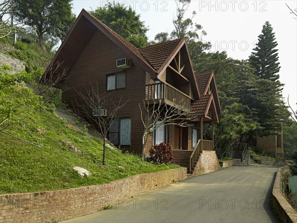 Exterior wood sided home with shingled roof and brick steps