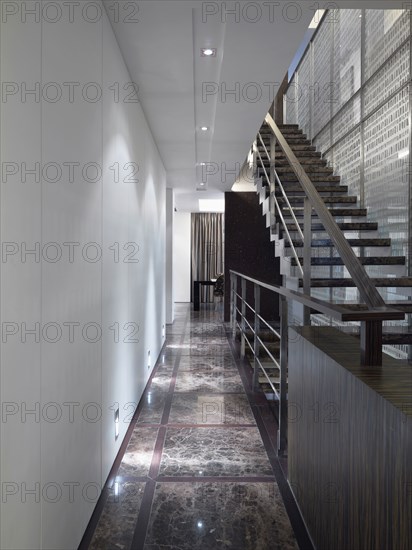Hallway along staircase in modern home