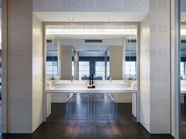 Large mirror and double sinks on modern bathroom