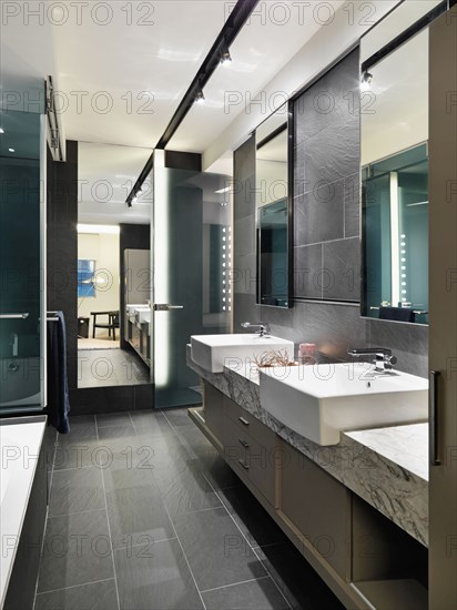 Slate tile floor and walls in modern bathroom