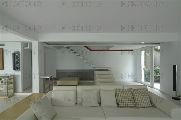 Sofa and floating staircase in modern home