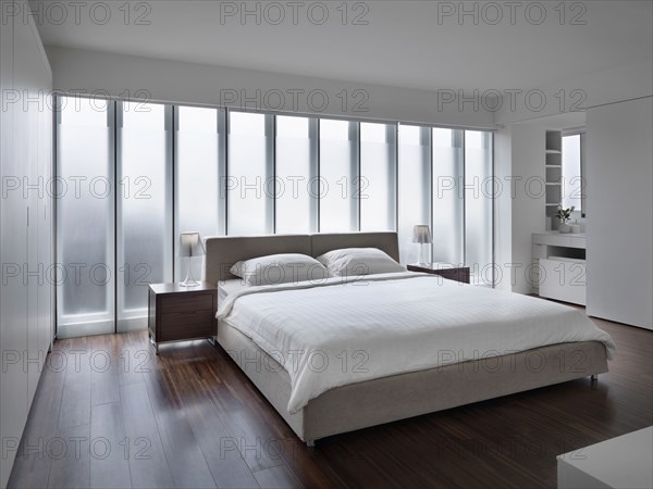 Modern white bedroom with hardwood floors