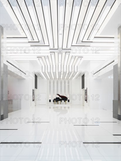 Baby grand piano in bright white room