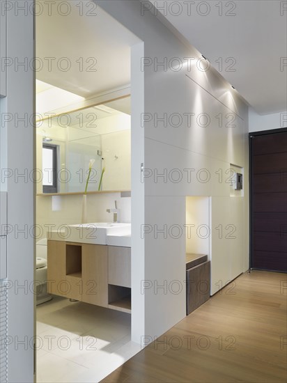 Hallway and doorway leading to modern bathroom