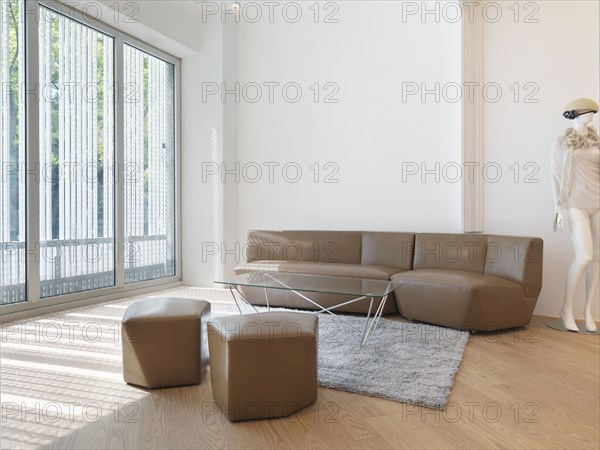 Living room with tan sofa and large windows