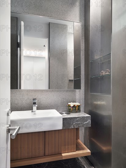 White sink on marble countertop in bathroom