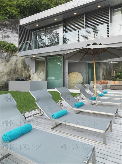 Row of lounge chairs outside modern home