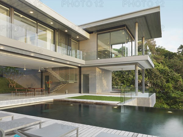 Multiple story modern home with swimming pool out front