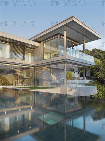 Multiple story modern home with swimming pool out front