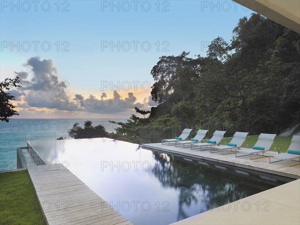 Swimming pool on ocean at modern home