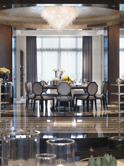 Elegant circular dining table beneath chandelier