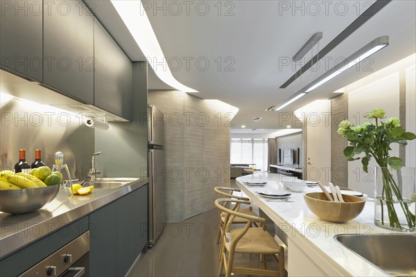 Kitchen island with sink and dining area