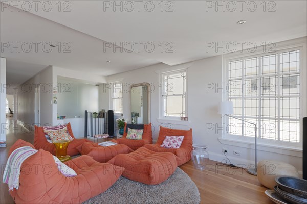 Modern orange lounge chairs in living room