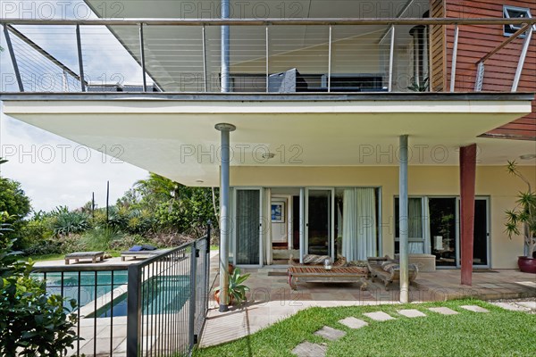 Exterior of house with porch and swimming pool