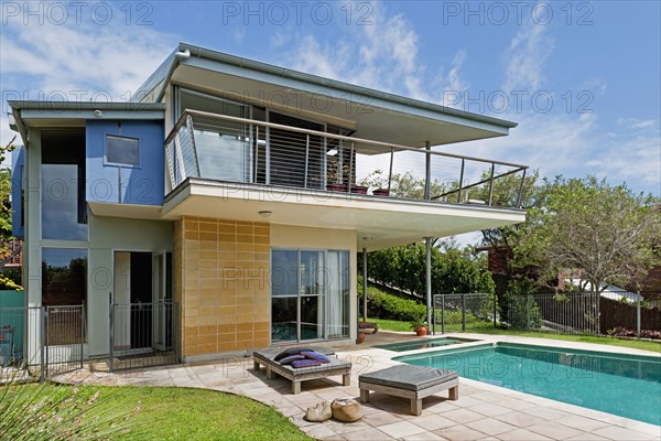 Swimming pool in front of house