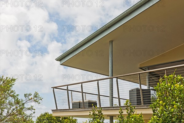 Balcony of residential building against cloudy sky